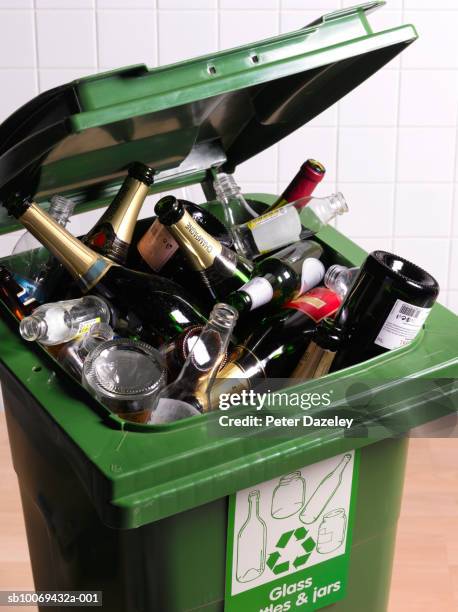 open recycling bin with full of glass bottles, close-up - glasbak stockfoto's en -beelden