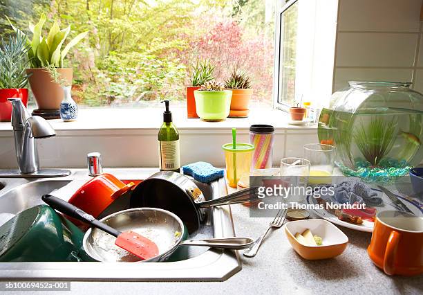 dirty dishes piled in kitchen sink, close-up - porslin bildbanksfoton och bilder