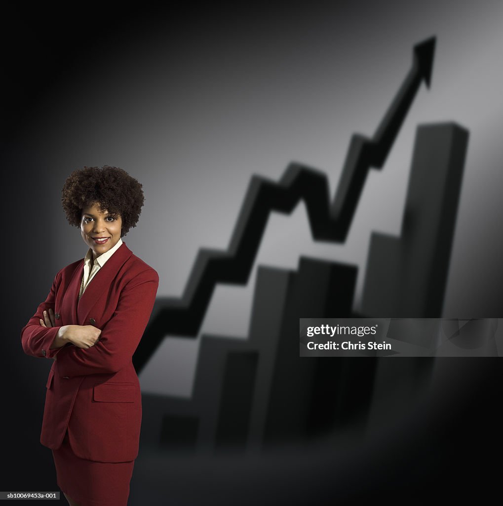 Studio portrait of businesswoman with graphs behind