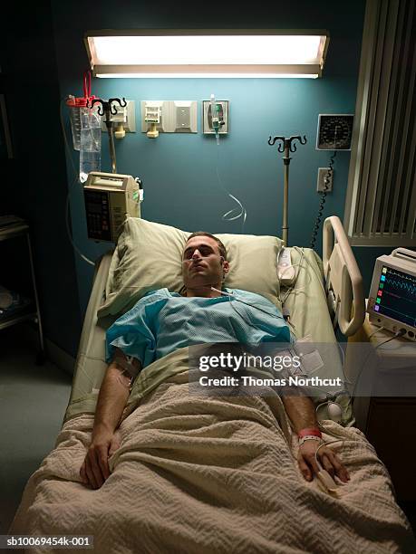 patient sleeping in hospital bed - man in hospital stock pictures, royalty-free photos & images