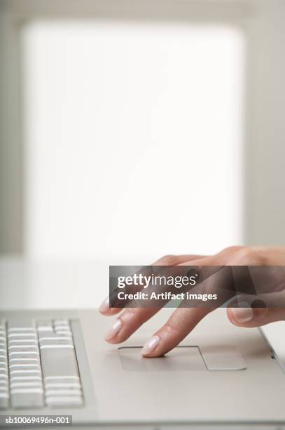 woman using laptop, close up of hand - touchpad stock-fotos und bilder