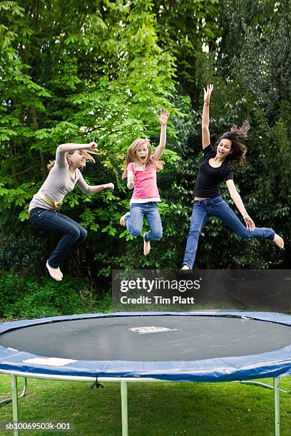 girls (12-13) jumping on trampoline - trampolin bildbanksfoton och bilder