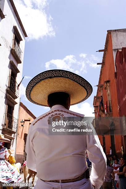 mexico, guanajuato, san miguel de allende, man in charro costume on street, rear view - sombrero stock pictures, royalty-free photos & images