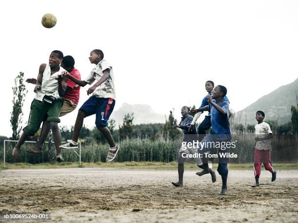 south africa, cape town, hout bay, boys (14-17) and men playing soccer - teen boy barefoot stock pictures, royalty-free photos & images