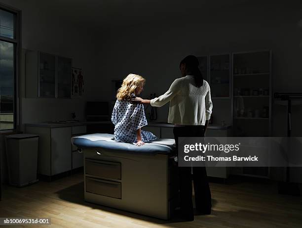 female doctor talking to patient in examination room - examination table stock pictures, royalty-free photos & images