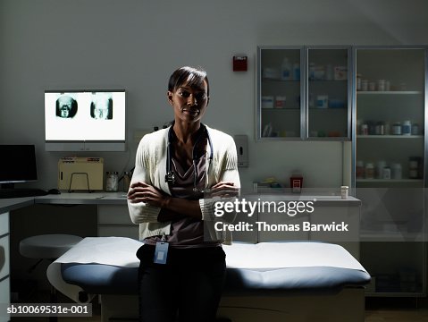 Female doctor in examination room smiling, portrait