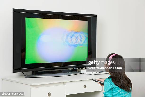 girl (8-9) watching television - young choice beijing activity stock pictures, royalty-free photos & images