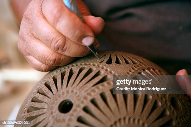 mexico, oaxaca, man making black ceramic decorative pottery, close-up of hands - oaxaca foto e immagini stock