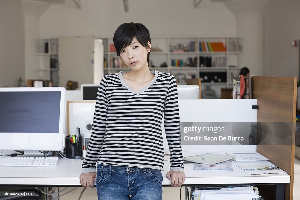 Woman standing in office, portrait