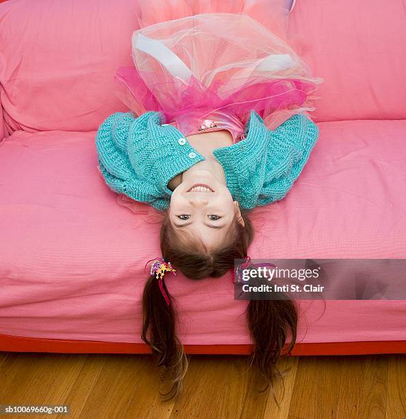 portrait of girl (4-5 years) in pink tutu lying on sofa upside down - maria chiquinha - fotografias e filmes do acervo