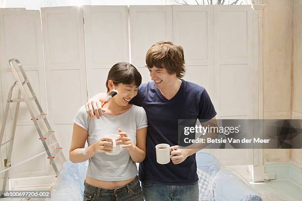 couple with paint smears drinking coffee - messy boyfriend stock pictures, royalty-free photos & images