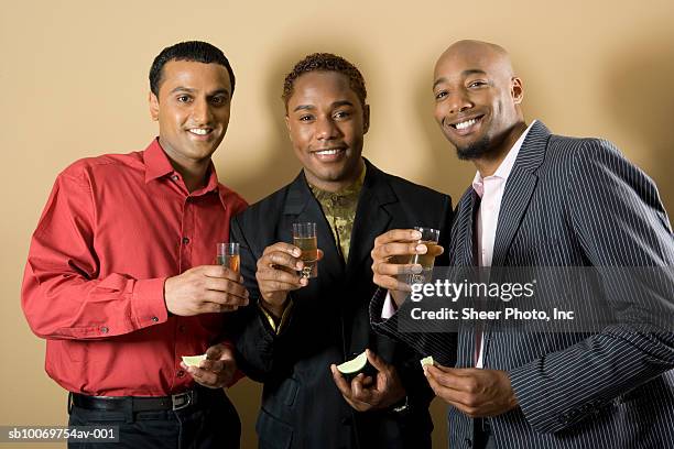 three men with shots of tequila, studio portrait - friends studio shot stock pictures, royalty-free photos & images