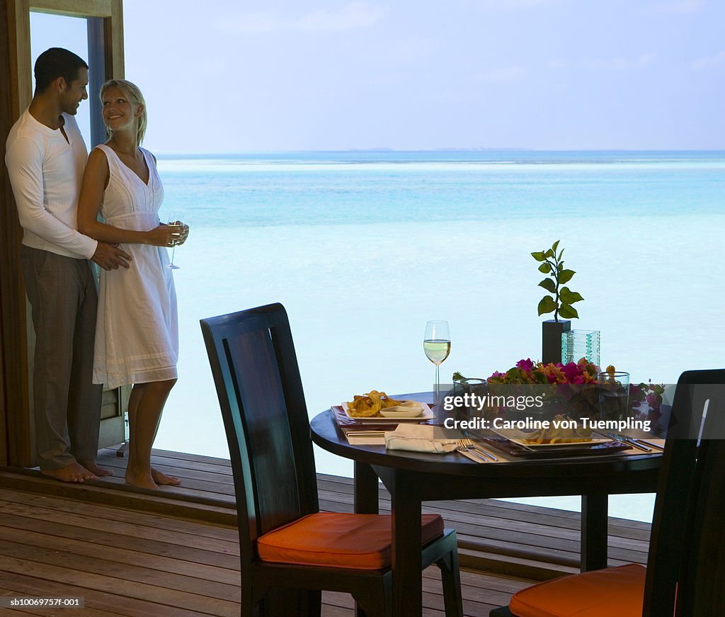 Young couple in outdoor restaurant by sea