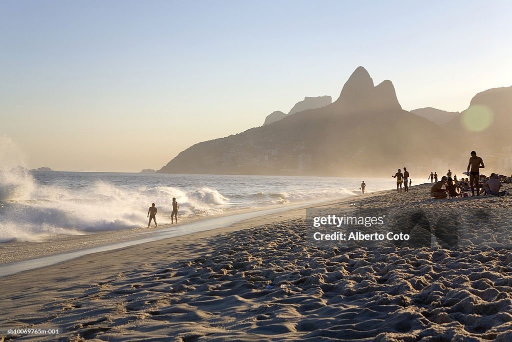 Brazil, Rio de Janeiro, people on Panema Beach near Dois Irmaos at sunset