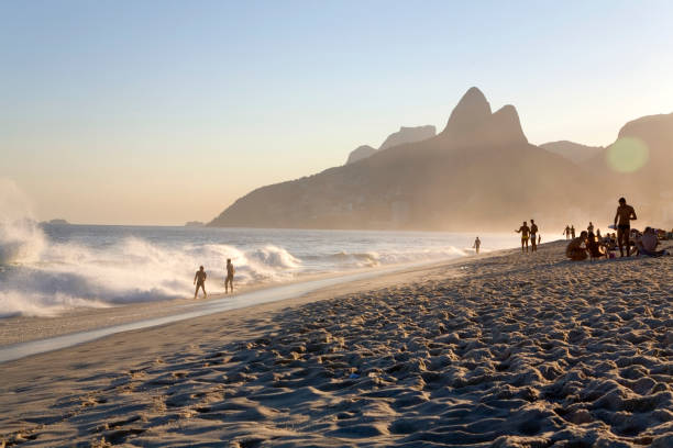 Brazil, Rio de Janeiro, people on Panema Beach near Dois Irmaos at sunset