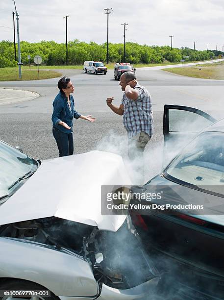 mature man and woman fighting on road - motor vehicle accident injury stock pictures, royalty-free photos & images