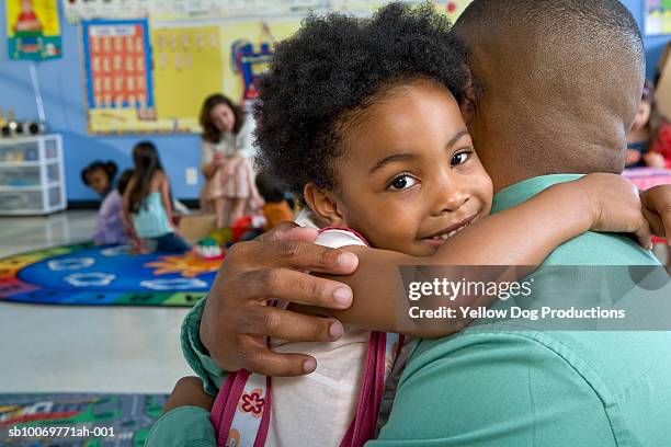 girl (4-5) embracing father in classroom - arab student kids stock pictures, royalty-free photos & images