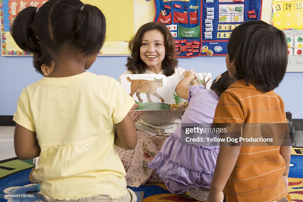 Teacher reading book in classroom