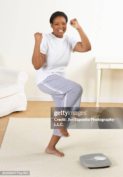 portrait of woman in fight stance in living room - fighting stance stock pictures, royalty-free photos & images