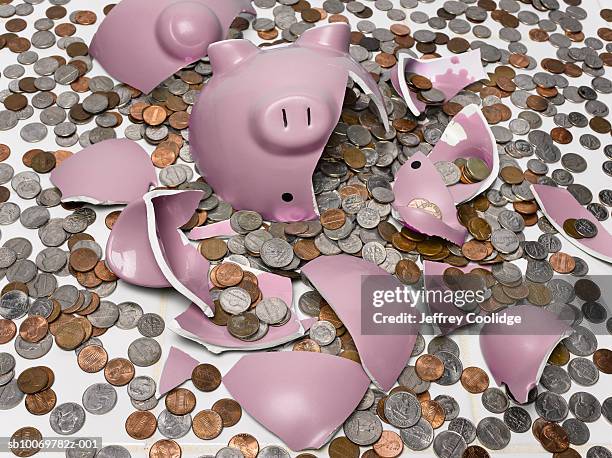 pink piggy bank smashed with coins on floor - smashed piggy bank stock pictures, royalty-free photos & images