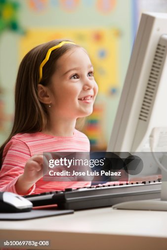 Girl Using Computer Smiling High-Res Stock Photo - Getty Images