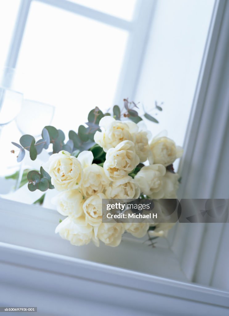 Bouquet of tulip and eucalyptus on window sill