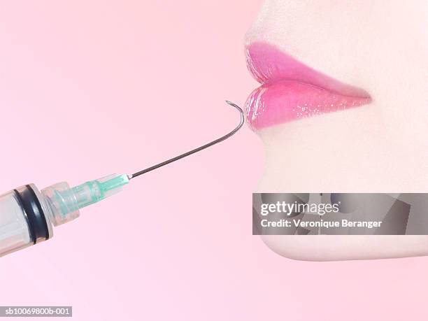 syringe and woman's mouth - beauty shot of young woman stock-fotos und bilder