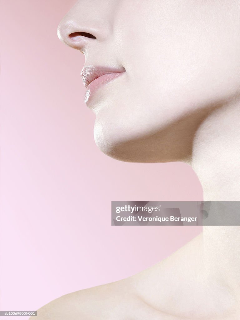 Studio shot of young woman, close-up of neck and chin