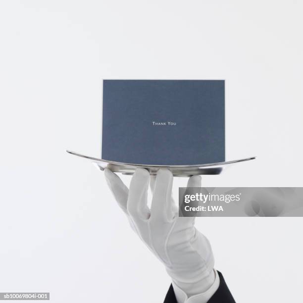 waiter with greeting card on serving tray, close up of hand - white glove fotografías e imágenes de stock