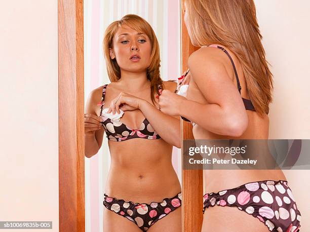 teenage girl (16-17) stuffing tissue paper in bra - girls in bras bildbanksfoton och bilder