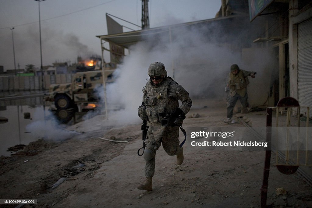 Iraq, Baghdad, soldiers running after missile launch