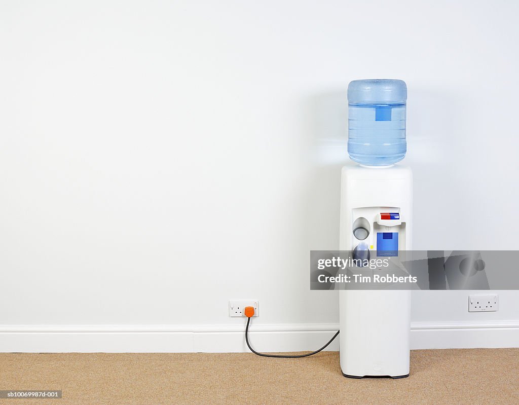 Water cooler plugged into wall in office, close-up