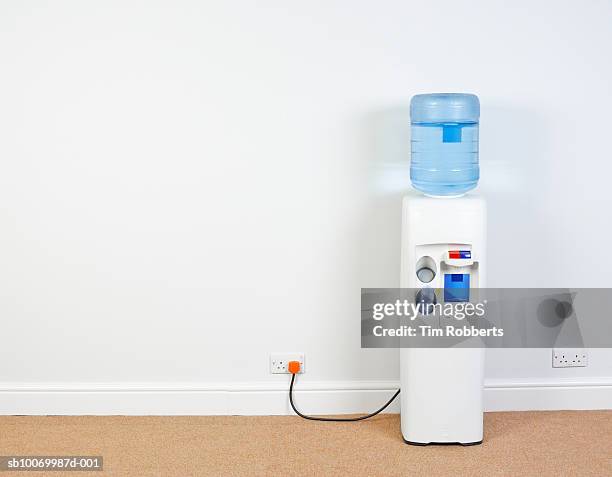 water cooler plugged into wall in office, close-up - purified water stock pictures, royalty-free photos & images