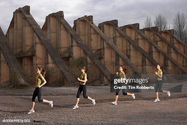 young woman athlete running by old ruins, multiple exposure - center athlete stock pictures, royalty-free photos & images