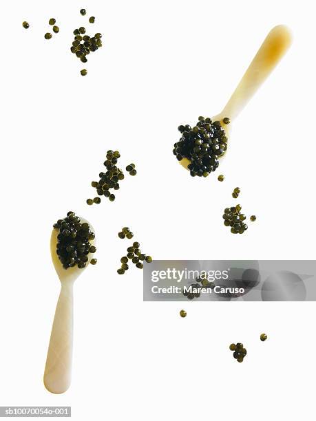 two spoons of caviar and bits around - caviar stock pictures, royalty-free photos & images