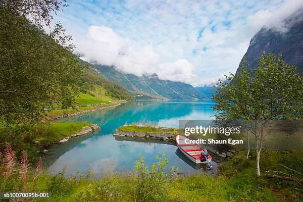 norway,  western fjords, nordfjord, rowboat on lake in mountains - olden norwegen stock-fotos und bilder