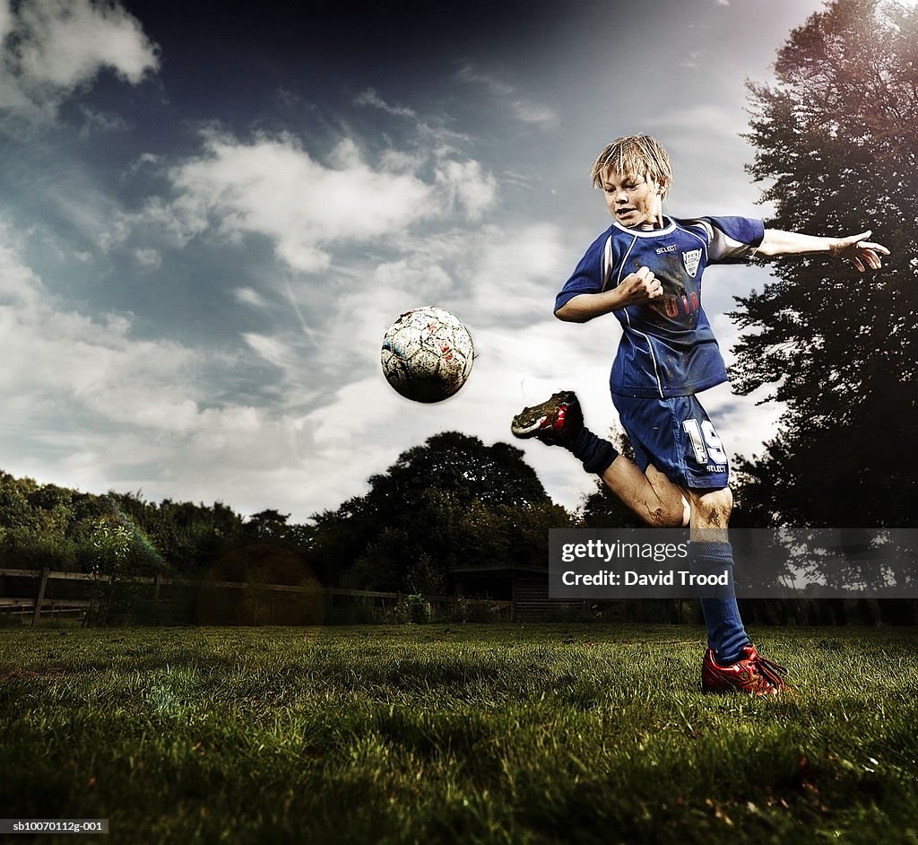 Boy (10-11) playing soccer