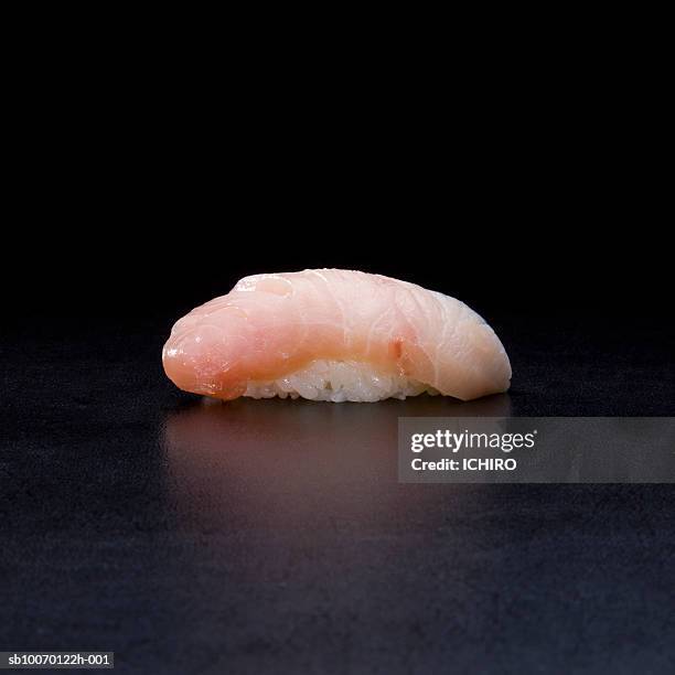 buri nigiri sushi on black background - japanese amberjack stock pictures, royalty-free photos & images