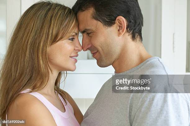 close-up side view of boyfriend and girlfriend about to kiss - about stock pictures, royalty-free photos & images