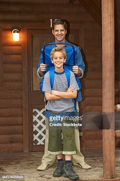 portrait of a father and his son (10-11) who is wearing a backpack - is stock pictures, royalty-free photos & images