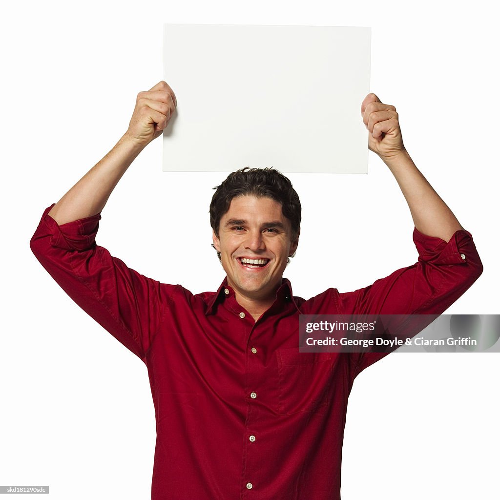 Portrait of man holding a blank card on his head