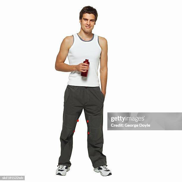 front view of man holding sports bottle - holding bottle stock pictures, royalty-free photos & images