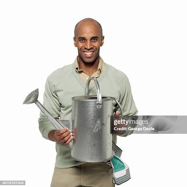 portrait of a man holding a watering can - pour spout stock pictures, royalty-free photos & images