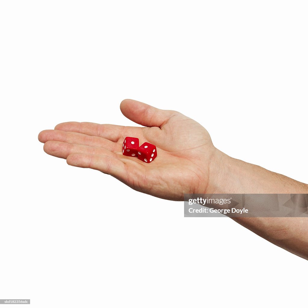 Close-up of man's hand holding two dices