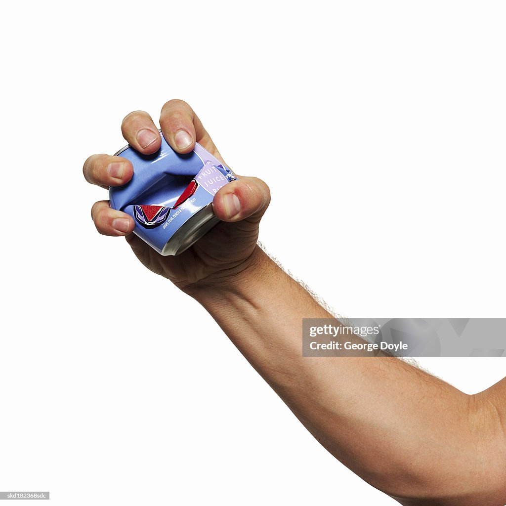 Close-up of man's hand squashing tin can
