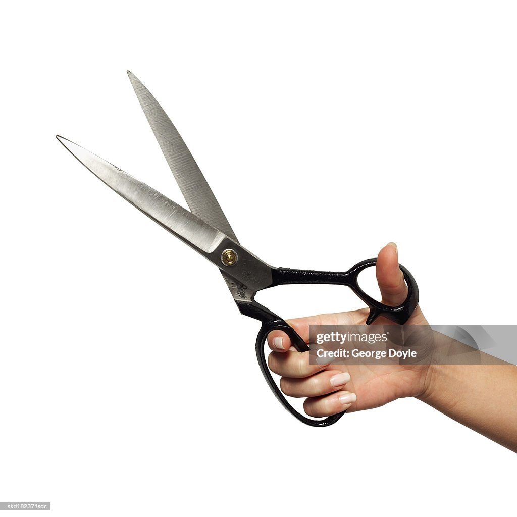 Close-up of man's hand holding scissors