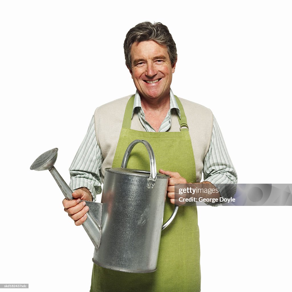 Portrait of a man holding a watering can