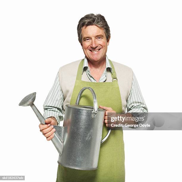 portrait of a man holding a watering can - pour spout stock pictures, royalty-free photos & images