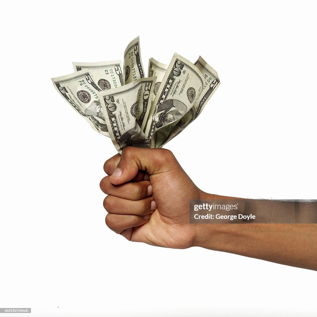 Close up view of a hand holding bank notes