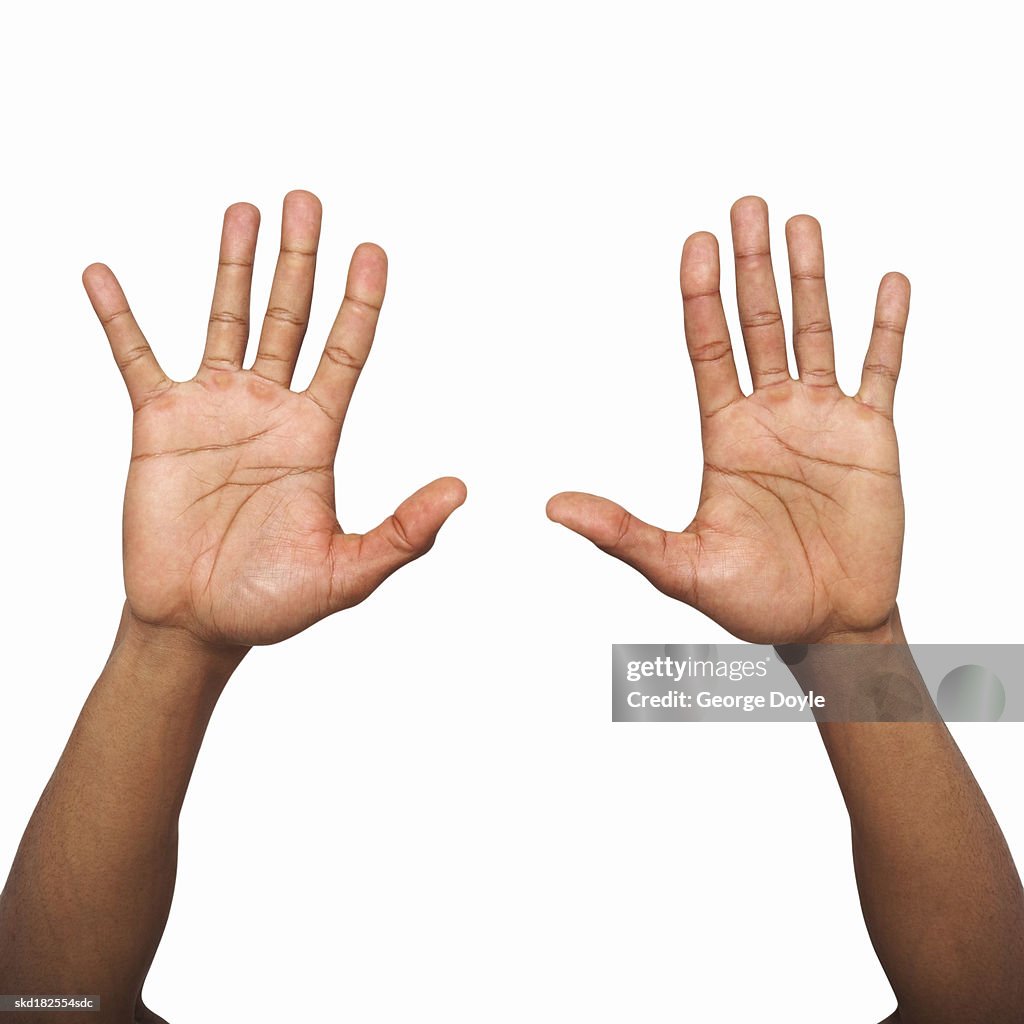 Closeup Of Male Hand Holding Two Hands Up High-Res Stock Photo